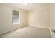 Neat room showcasing a window for natural light, neutral walls, and carpet floors at 300 Twin Tendrils Sw, Atlanta, GA 30331