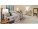 Bright bedroom featuring neutral walls, plush carpet, and decorative furniture accents at 300 Twin Tendrils Sw, Atlanta, GA 30331