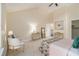 Cozy bedroom showcasing vaulted ceilings, neutral walls, and a seating area for relaxation at 300 Twin Tendrils Sw, Atlanta, GA 30331