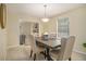 Bright dining room featuring an elegant table set, neutral walls, and a view into the cozy living space at 300 Twin Tendrils Sw, Atlanta, GA 30331