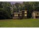 Charming two-story home with a stone foundation and lush greenery at 300 Twin Tendrils Sw, Atlanta, GA 30331