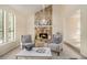 Inviting living room boasts a stone fireplace, high ceilings, and natural light at 300 Twin Tendrils Sw, Atlanta, GA 30331