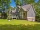 Home's backyard featuring well-maintained lawn and deck with gazebo and ground level garage at 507 Wintergreen Way, Canton, GA 30115