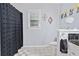 Cozy bathroom featuring a decorative shower curtain and patterned tile flooring at 507 Wintergreen Way, Canton, GA 30115