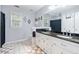 Bright bathroom with a double sink vanity, decorative mirrors, and a neutral color palette at 507 Wintergreen Way, Canton, GA 30115