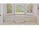 Relaxing soaking tub set beneath large windows in tiled bathroom at 507 Wintergreen Way, Canton, GA 30115