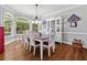 Bright dining room featuring hardwood floors, large windows, and a stylish hutch at 507 Wintergreen Way, Canton, GA 30115