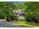 Charming home with a lush landscaped front yard, inviting porch and brick paved driveway at 507 Wintergreen Way, Canton, GA 30115