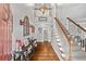 Inviting foyer featuring hardwood floors, staircase, and decorative lighting at 507 Wintergreen Way, Canton, GA 30115