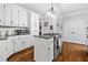 Bright kitchen with white cabinets, granite countertops, and stainless steel oven at 507 Wintergreen Way, Canton, GA 30115
