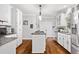 Well-lit kitchen featuring white cabinets, granite countertops, and stainless steel appliances at 507 Wintergreen Way, Canton, GA 30115