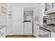 Efficient laundry room with front loading washer and dryer behind folding doors, plus white cabinetry at 507 Wintergreen Way, Canton, GA 30115