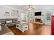 Open living room featuring hardwood floors, fireplace, and comfortable seating at 507 Wintergreen Way, Canton, GA 30115