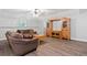 Inviting living room featuring a large brown sofa, hardwood floors, and a custom entertainment center at 507 Wintergreen Way, Canton, GA 30115