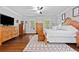 Inviting main bedroom featuring hardwood floors, ceiling fan, large windows, and ample space at 507 Wintergreen Way, Canton, GA 30115