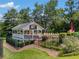 Community pool house with outdoor seating, lush landscaping, and fenced perimeter at 507 Wintergreen Way, Canton, GA 30115