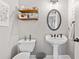 Classic half bathroom with pedestal sink, updated fixtures, and a decorative mirror at 507 Wintergreen Way, Canton, GA 30115