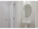 A clean, modern bathroom with a pedestal sink and oval mirror at 913 Agate Ln, Lawrenceville, GA 30043