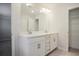 Bright bathroom features a double sink vanity with quartz countertop and ample storage space at 913 Agate Ln, Lawrenceville, GA 30043