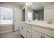 Elegant bathroom featuring double vanity with quartz countertop, modern fixtures and tiled floor at 913 Agate Ln, Lawrenceville, GA 30043
