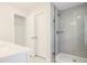 Bright bathroom featuring tiled walk-in shower, white cabinets and counters at 913 Agate Ln, Lawrenceville, GA 30043