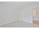 Bright bedroom featuring carpet, a double-door closet, and a connecting doorway at 913 Agate Ln, Lawrenceville, GA 30043
