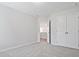 Well-lit bedroom featuring soft carpeting, a closet, and access to an open doorway at 913 Agate Ln, Lawrenceville, GA 30043