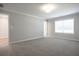 Spacious carpeted bedroom with large window and neutral-colored walls at 913 Agate Ln, Lawrenceville, GA 30043