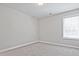Comfortable bedroom featuring neutral walls, soft carpeting, and a window with natural light at 913 Agate Ln, Lawrenceville, GA 30043