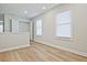 Hallway with wood floors and windows on one side at 913 Agate Ln, Lawrenceville, GA 30043