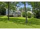 Beautiful backyard featuring a deck, mature trees, and well-maintained lawn at 1046 S Mcdonough St, Decatur, GA 30030