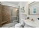 Bathroom featuring tiled shower with glass door, vanity and linen storage at 1046 S Mcdonough St, Decatur, GA 30030