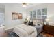 Comfortable bedroom features hardwood floors, ceiling fan and shuttered windows at 1046 S Mcdonough St, Decatur, GA 30030