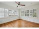 Serene bedroom with white walls, plantation shutters, hardwood floors, and a modern ceiling fan at 1046 S Mcdonough St, Decatur, GA 30030