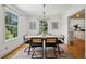 Elegant dining room with hardwood floors, modern chandelier, and seamless flow to the kitchen at 1046 S Mcdonough St, Decatur, GA 30030