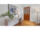 Inviting foyer featuring a wooden door, hardwood floors, a stylish console table, and elegant decor at 1046 S Mcdonough St, Decatur, GA 30030