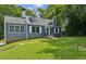 Charming blue two-story home with dormer windows and a well-maintained lawn and mature trees at 1046 S Mcdonough St, Decatur, GA 30030