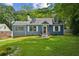 Charming blue two-story home with dormer windows and a well-maintained lawn and mature trees at 1046 S Mcdonough St, Decatur, GA 30030
