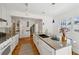 Open kitchen features granite counters, island with sink, bar seating, and appliances at 1046 S Mcdonough St, Decatur, GA 30030