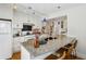 Well-lit kitchen with granite counters, island, stainless appliances, and bar seating at 1046 S Mcdonough St, Decatur, GA 30030