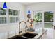 Kitchen sink features granite counters, stainless faucet, and slider to deck at 1046 S Mcdonough St, Decatur, GA 30030