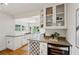 Kitchen area boasts modern wine rack, stainless wine cooler and granite counters at 1046 S Mcdonough St, Decatur, GA 30030