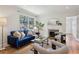 Bright living room with a cozy fireplace, comfortable seating, hardwood floors, and natural light at 1046 S Mcdonough St, Decatur, GA 30030