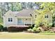 Charming home with a well-manicured front lawn and a welcoming entrance with a light blue front door at 1315 Pembridge Nw Way, Kennesaw, GA 30152