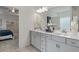 Well-lit bathroom with double sinks, modern fixtures, and a glimpse of the bedroom at 2 Silver Leaf Trl, Douglasville, GA 30134