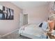 Soft-toned bedroom with floral wall decor, a cozy bed, and accent pillows showcases a peaceful ambiance at 2 Silver Leaf Trl, Douglasville, GA 30134