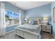Well-lit bedroom features a large window, a comfortable bed, and matching bedside tables with lamps at 2 Silver Leaf Trl, Douglasville, GA 30134