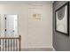 Upstairs hallway with 9' ceilings and view of stairway at 2 Silver Leaf Trl, Douglasville, GA 30134