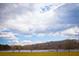Scenic view of a lake surrounded by trees under a partly cloudy sky at 2 Silver Leaf Trl, Douglasville, GA 30134