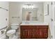 Bathroom featuring wood vanity, toilet, mirror, and hardware at 300 Johnson Ferry Ne Rd # A811, Atlanta, GA 30328